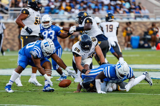 DeWayne Carter, left, scoops what became a 35-yard fumble return for a touchdown against North Carolina A&T on Saturday night. 