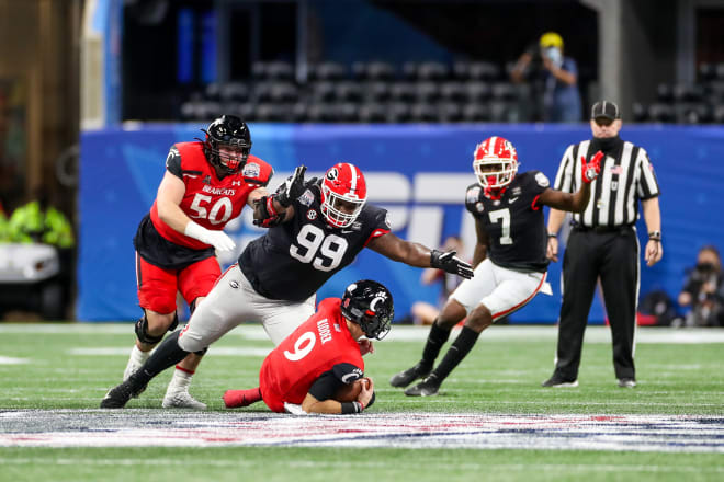Jordan Davis forced Desmond Ridder to slide while recording a sack during the Chick-fil-A Peach Bowl. (Chamberlain Smith/UGA Sports Communications)