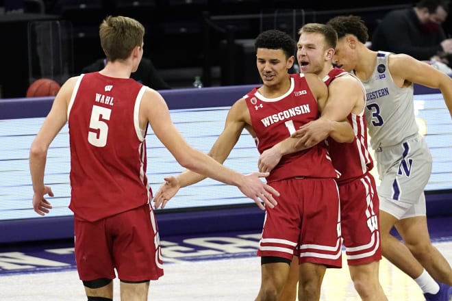 Wisconsin guard Jonathan Davis, center, celebrates with forward Tyler Wahl, left, and guard Brad Davison after scoring a basket in a victory over Northwestern.