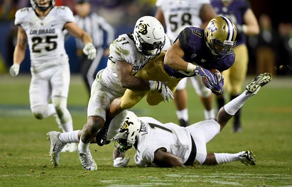 SANTA CLARA, CA - DECEMBER 02: Myles Gaskin #9 of the Washington Huskies is tackled by Kenneth Olugbode #31 of the Colorado Buffaloes during the Pac-12 Championship game at Levi's Stadium on December 2, 2016 in Santa Clara, California. (Photo by Thearon W. Henderson/Getty Images)