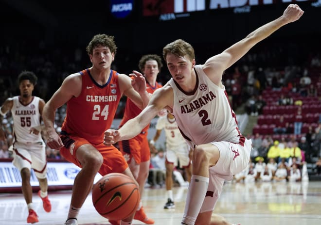 Clemson Tigers center PJ Hall (24) and Alabama Crimson Tide forward Grant Nelson (2) chase a ball during the second half at Coleman Coliseum. Clemson defeated Alabama 85-77. Photo | Gary Cosby Jr.-USA TODAY Sports