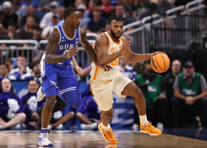 Tennessee's Josiah-Jordan James, right, dribbles past Duke's Dariq Whitehead. 