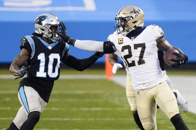 New Orleans Saints safety Malcolm Jenkins stiff-arms Carolina Panthers H-back Curtis Samuel during an interception on Jan. 3, 2021.