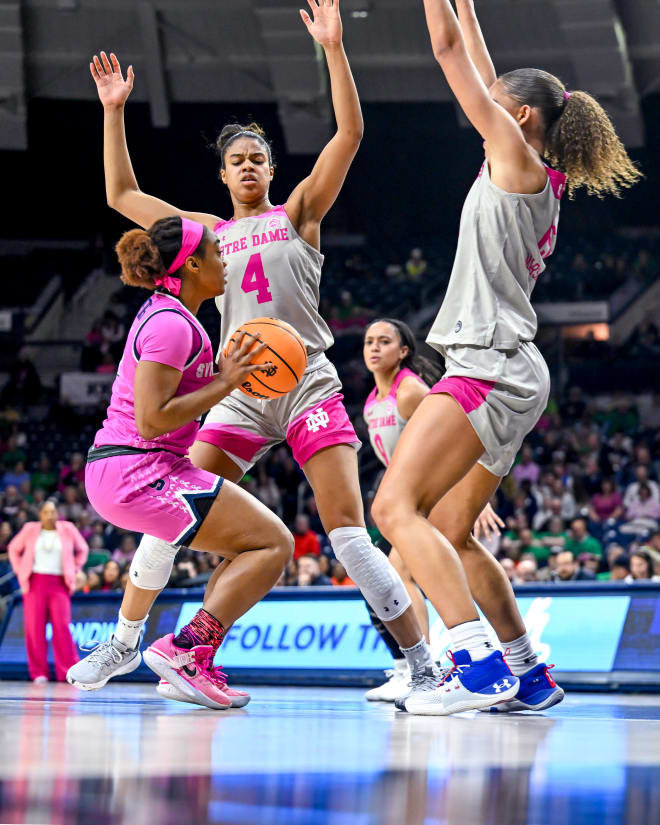 Notre Dame's Cass Propser (4) and Natalijia Marshall (15) defend Syracuse's Kennedi Perkins Sunday at Purcell Pavilion.