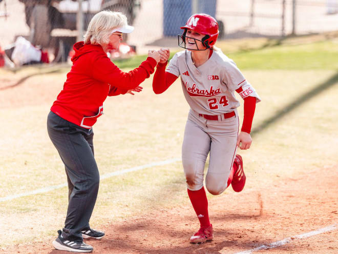 Ava Bredwell helped Nebraska softball coach Rhonda Revelle (left) record her 1,100th win with the Huskers