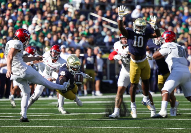Isaiah Foskey (left) and Prince Kollie (10) go after a punt in ND's 44-21 victory over UNLV on Saturday.