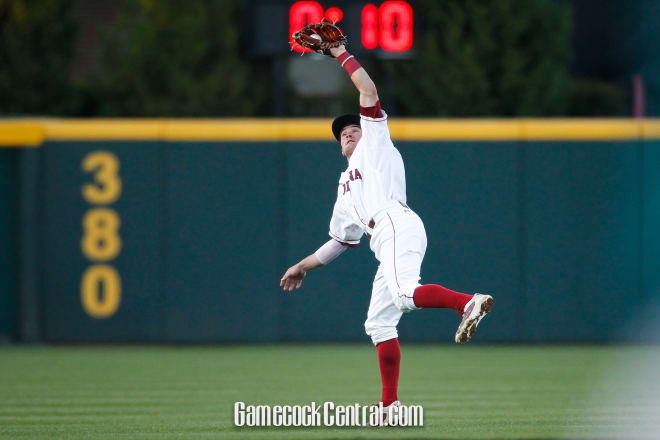 Marcus Mooney dives back to catch a ball for an out in Tuesday's game.