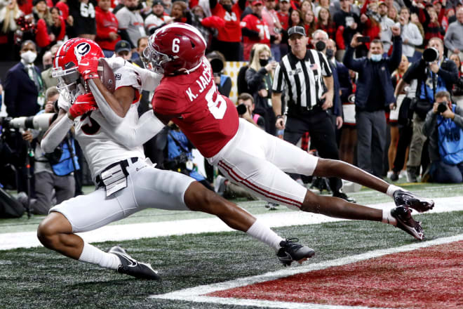 Georgia Bulldogs wide receiver Adonai Mitchell (5) catches a touchdown pass while being guarded by Alabama Crimson Tide defensive back Khyree Jackson (6) during the College Football Playoff National Championship at Lucas Oil Stadium in Indianapolis. Photo | Jenna Watson-USA TODAY Sports