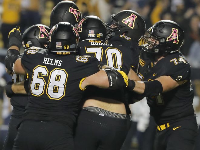 Mountaineers place kicker Chandler Staton (top left) is hoisted up by teammates following a last second game winning field goal against the Coastal Carolina 