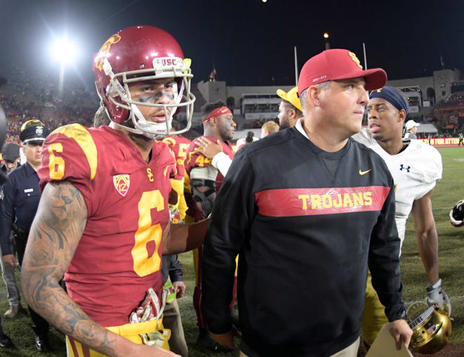 USC head coach Clay Helton and wide receiver Michael Pittman walk off the field after the Trojans' 24-17 season-ending loss to Notre Dame on Saturday night.