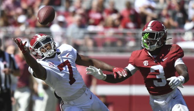 White team wide receiver Ja'Corey Brooks (7) reaches out for a pass as he is defended by Crimson team defensive back Terrion Arnold (3) at Bryant-Denny Stadium. Photo | Gary Cosby-USA TODAY Sports