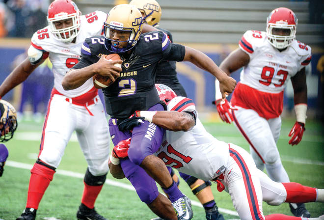 Former James Madison quarterback Vad Lee gets tackled during a game against Stony Brook in 2015.