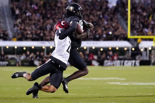 Cincinnati Bearcats wide receiver Tyler Scott (21) is unable to catch a pass against former UCF Knights defensive back Justin Hodges (12) in the fourth quarter at FBC Mortgage Stadium. UCF won 25-21. Mandatory Credit: Kareem Elgazzar/The Cincinnati Enquirer Sentinel via USA TODAY NETWORK