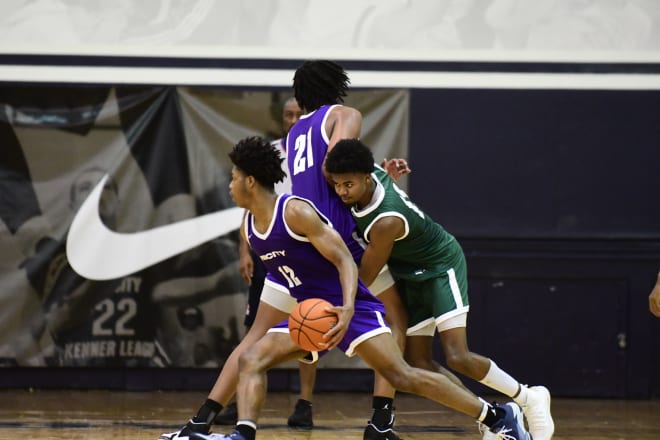 G'Town's Jordan Riley and Ryan Mutombo in pick and roll, defended by Hakim Hart of Maryland. 