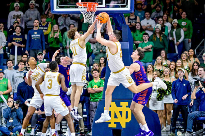Notre Dame men's basketball lost two players to the transfer portal on Thursday, including forward Matt Zona, who is pictured above on the right with the ball.