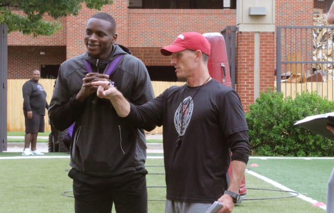 Adebawore chats with Brent Venables during OU's summer camp on June 2.