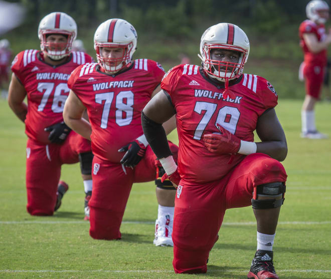 NC State Wolfpack football offensive tackle Ikem Ekwonu (79) stretches.