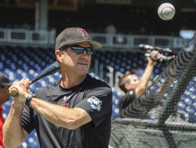 Texas Tech baseball coach Tim Tadlock takes a swing during the Red Raider practice session at the College World Series in Omaha, Nebraska.