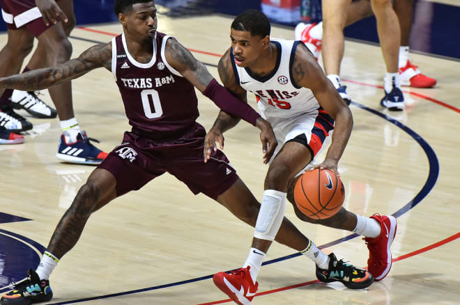 Rebels guard Luis Rodriguez (15) handles the ball against Texas A&M Aggies guard Jay Jay Chandler (0) during the first half at The Pavilion at Ole Miss.