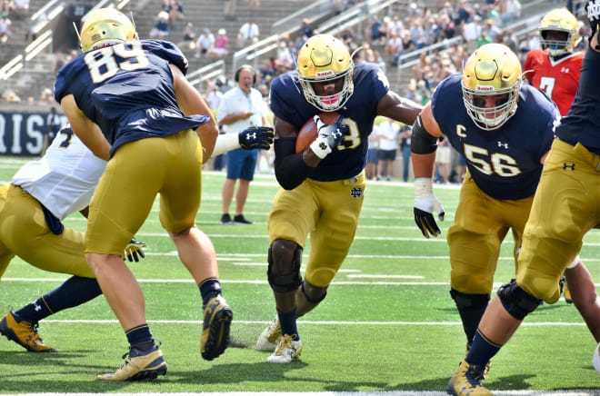 New captain Josh Adams runs behind fullback/tight end Brock Wright (89) and Quenton Nelson (56) for the first TD in Sunday's scrimmage at Notre Dame Stadium.