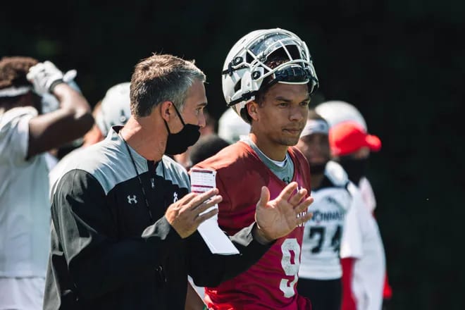 Gino Guidugli (left) helped develop two-star prospect Desmond Ridder (right) into an NFL draft pick.