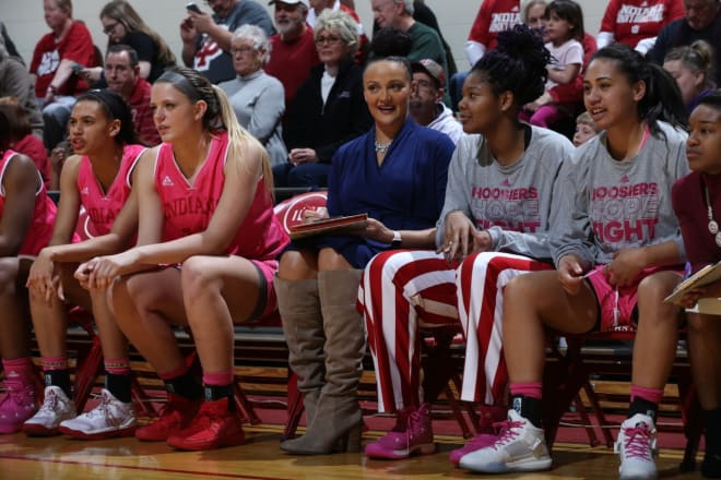 Nine-year WNBA veteran Mistie Bass sits in between IU freshman forward Darby Foresman and sophomore center Danielle Williams in the Indiana bench. Bass tracks stats during the games.