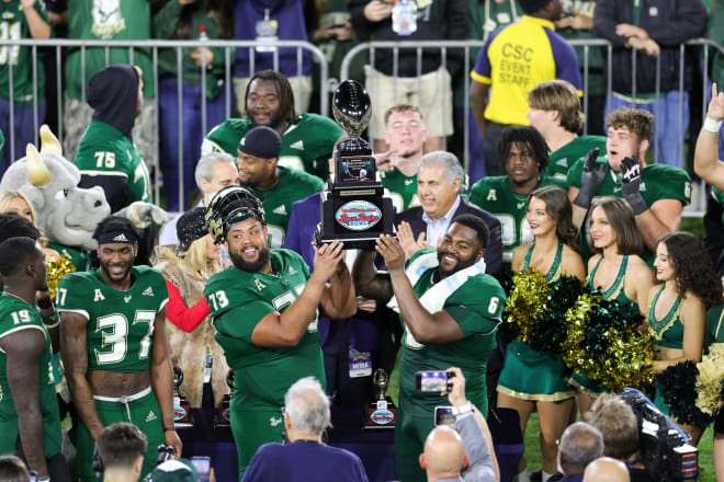 Donovan Jennings and Immanuel Hickman hold up the Boca Bowl Championship Trophy