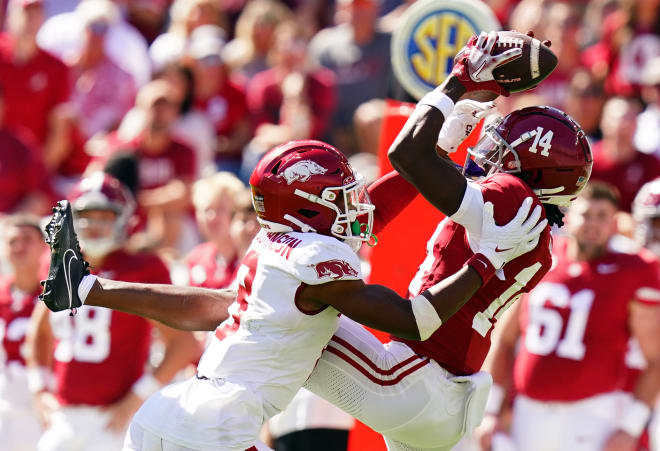 Alabama Crimson Tide wide receiver Jalen Hale (14) tries to hang onto the ball against Arkansas Razorbacks defensive back Jayden Johnson (8) during the second half at Bryant-Denny Stadium. Photo | John David Mercer-USA TODAY Sports