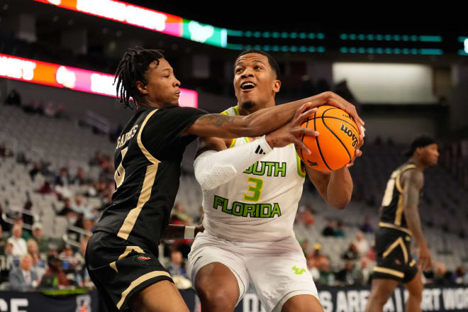 Mar 16, 2024; Fort Worth, TX, USA; South Florida Bulls guard Chris Youngblood (3) drives to the basket and is fouled by UAB Blazers guard Eric Gaines (4) during the first half at Dickies Arena. | Photo: Chris Jones-Imagn Images