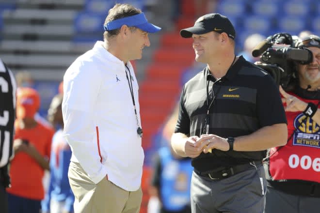 UF coach Dan Mullen (left) with Arkansas interim coach Barry Odom (right) before the Florida-Missouri game in 2018. (Kim Klement-USA TODAY Sports)