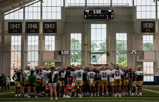 The Notre Dame football team huddles afte a recent practice at the Irish Athletics Center. 