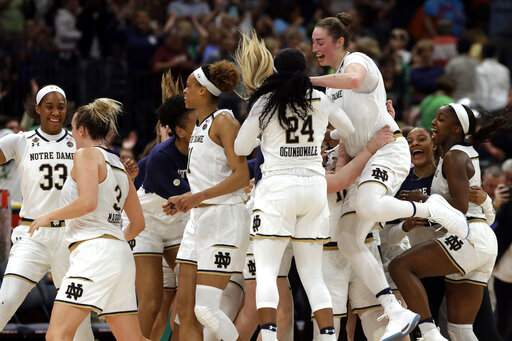 Notre Dame players celebrate their 81-76 triumph against top rival UConn to advance to national title game.