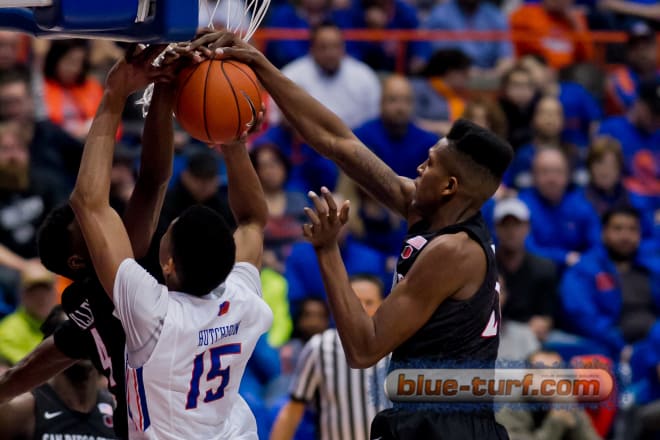 Boise State's Chandler Hutchison (15) is blocked going to the basket by SDSU's Malik Pope (R) and Dakarai (4) as he goes up for a shot.