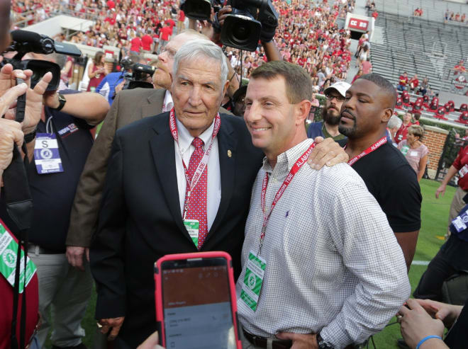 Former Alabama Crimson Tide head coach Gene Stallings talks with Clemson Tigers head coach Dabo Swinney on the field prior to the 1992 National Championship being honored at Bryant-Denny Stadium.