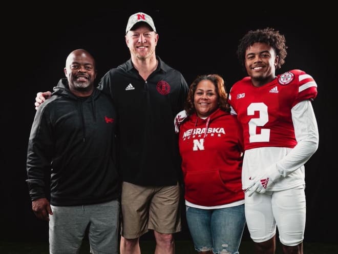 Versatile athlete Dylan Edwards with his family and Nebraska head coach Scott Frost