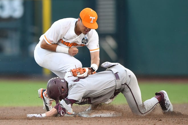 Tennessee's Dean Curley (23) tags Texas A&M's Travis Chestnut (4) out at second base during a NCAA College World Series game between Tennessee and Texas A&M at Charles Schwab Field in Omaha, Neb., on Saturday, June 22, 2024.