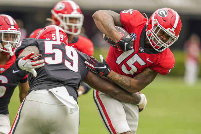 Georgia linebacker Trezmen Marshall (15) is tackled by offensive lineman Broderick Jones (59) after intercepting a pass during the Bulldogs’ spring game at Sanford Stadium. Mandatory Credit | Dale Zanine-USA TODAY Sports