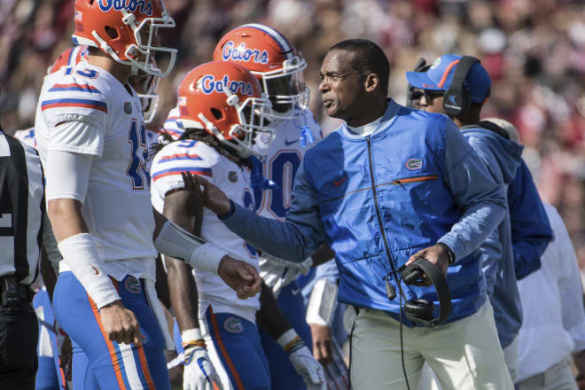 Florida head coach Randy Shannon talks with quarterback Feleipe Franks (13) during the first half of an NCAA college football game Saturday, Nov. 11, 2017, in Columbia, S.C. South Carolina defeated Florida 28-20.