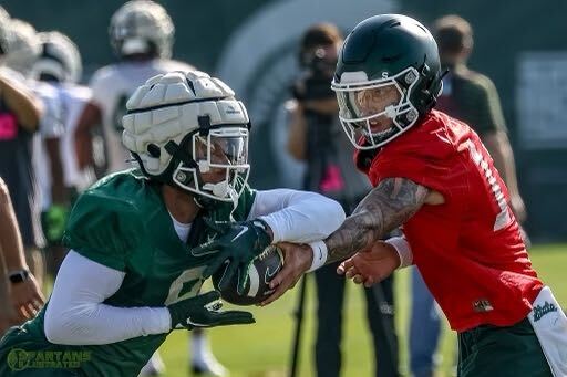 Noah Kim hands the ball off to running back Jalen Berger