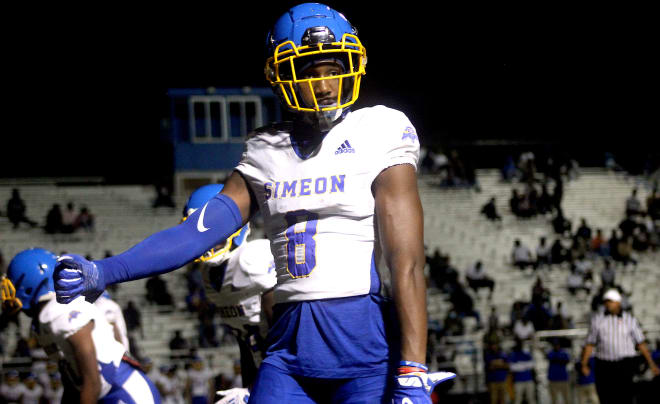 Chicago wide receiver Malik Elzy holds a Michigan Wolverines football recruiting offer 