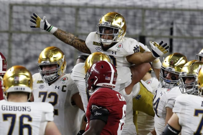 Notre Dame running back Kyren Williams gets hoisted in the air after scoring a touchdown against Alabama in a Jan. 1, 2021 College Football Playoff semifinal.