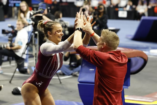 University of Alabama gymnast Lilly Hudson high fives assistant coach Justin Spring after performing on vault during the 2023 NCAA women's gymnastics regional at Lloyd Noble Center. Photo | Alonzo Adams-USA TODAY Sports