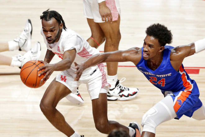 Houston guard DeJon Jarreau (3) gets a loose ball in front of Boise State forward Abu Kigab (24) during the first half of an NCAA college basketball game Friday, Nov. 27, 2020, in Houston. (AP Photo/Michael Wyke)