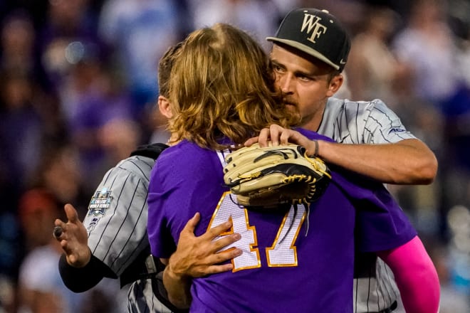 LSU third baseman Tommy White (47) and Wake Forest pitcher Camden Minacci (14), friends from their childhood days playing baseball in Tampa, embrace after White belted a walk-off two-run homer off Minacci in the Tigers' 2-0 College World Series win Thursday night.
