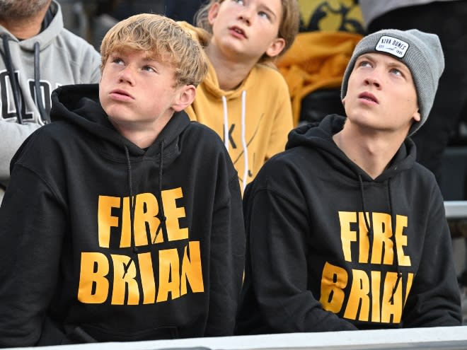 Two fans in Kinnick Stadium don "Fire Brian" shirts for Iowa's 12-10 loss to Minnesota on Saturday. 