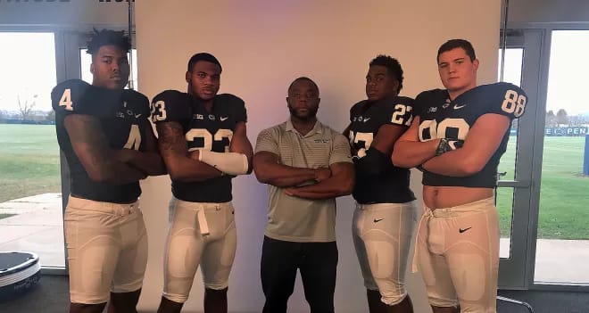 Ohio State defensive end Tyreke Smith, left, poses with Penn State commits and former defensive line coach Sean Spencer while on an official visit in 2017.