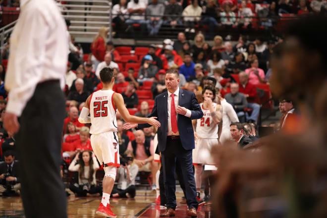 Texas Tech men's basketball head coach Chris Beard high-fives Davide Moretti as he comes out of the game in the first half against Eastern Illinois.