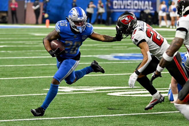 Detroit Lions running back Jahmyr Gibbs (26) runs with the ball against Tampa Bay Buccaneers cornerback Zyon McCollum (27) during the second half in a 2024 NFC divisional round game at Ford Field. | Photo: Lon Horwedel-USA TODAY Sports