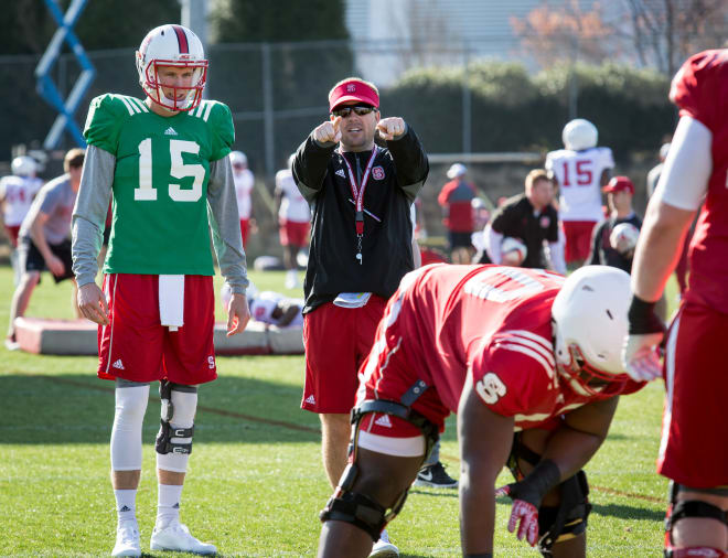 Offensive coordinator Eli Drinkwitz provides pointers for redhsirt junior quarterback Ryan Finley.