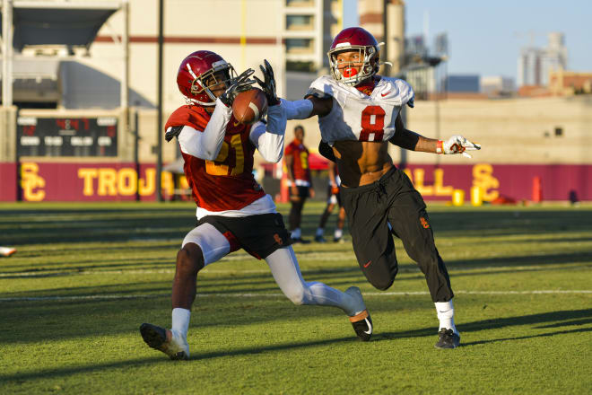 Tyler Vaughns tries to come down with a reception against Chris Steele on Monday.